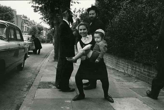Jewish family on sidewalk, London, England, 1971